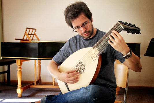 Vinícius Perez tenant un luth Renaissance 8c LLD® dans un cadre professionnel
